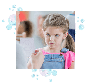 A girl looking at a flashcard.