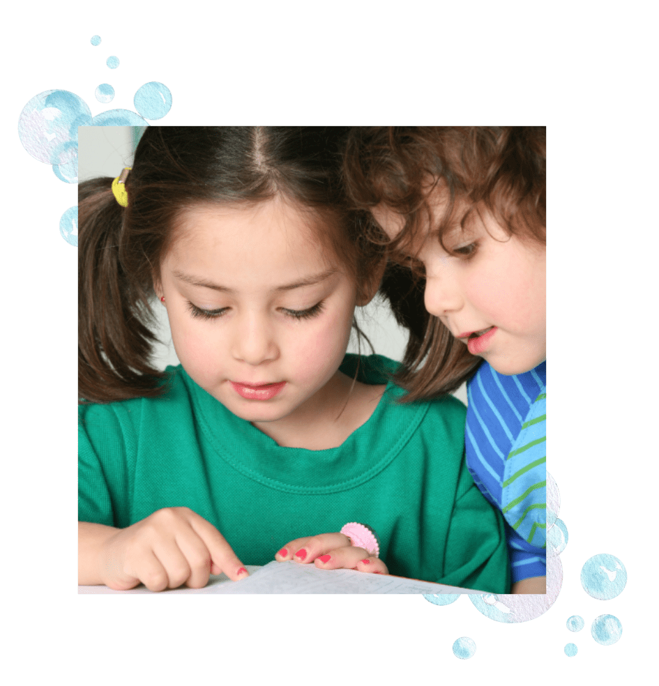 Two children reading a book using spatial visual skills.