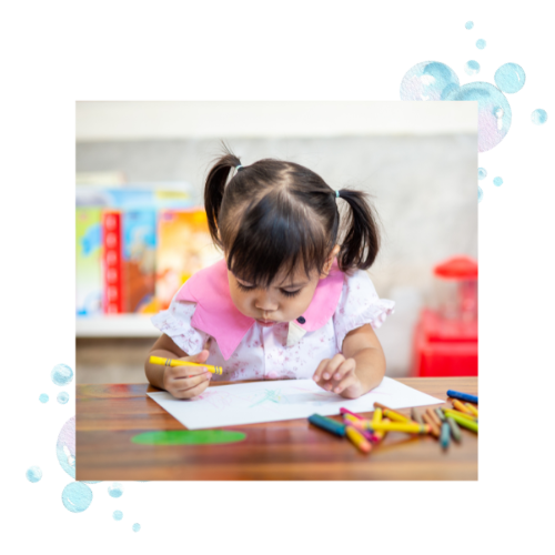 A girl coloring at a table where visual motor integration skills are worked on. 