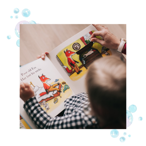 A young boy reading a picture book. 